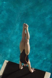 high angle view of a female diver diving into the pool