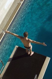 high angle view of a male diver ready to dive into the pool