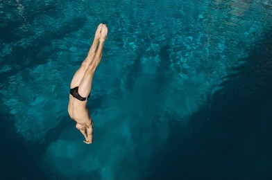 high angle view of a man diving into the pool