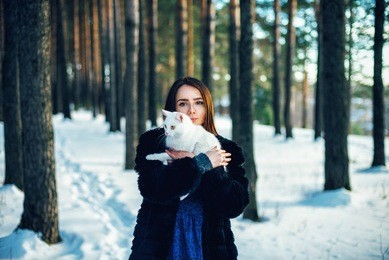 
girl in the forest with a cat
