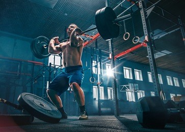 fit young man lifting barbells working out at a gym. sport, fitness, weightlifting, bodybuilding, training, athlete, workout exercises concept