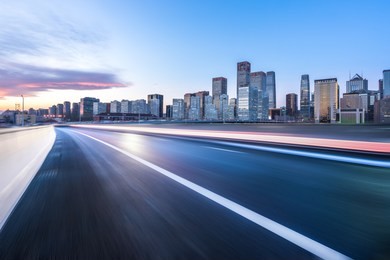 empty asphalt road with city skyline