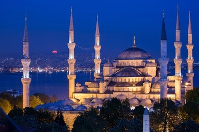 blue mosque at night with golden illumination, wide view of istanbul in dusk. sultanahmet camii mosque with six minarets - famous islamic monument of the ottoman architecture in turkey.