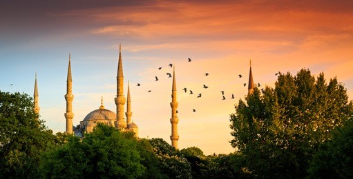 blue mosque at night with golden illumination, wide view of istanbul in dusk. sultanahmet camii mosque with six minarets - famous islamic monument of the ottoman architecture in turkey.