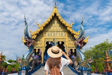 tourist is traveling at blue temple (wat rong suea ten) in chiangrai, thailand.