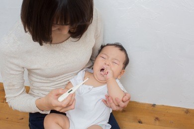 asian young mom with fussy baby