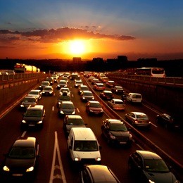 evening traffic. the city lights. car traffic against the sunset background.