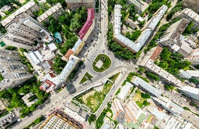 aerial city view with crossroads and roads, houses, buildings, parks and parking lots, bridges. helicopter drone shot. wide panoramic image.