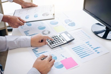 business accountant or banker, business partner calculate and analysis with stock financial indices and financial costs wisely and carefully, investment and finance concept.