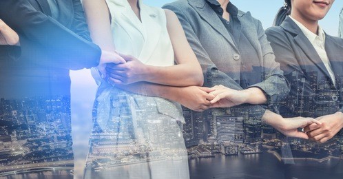 double exposure business people holding hands together showing workers relationship, unity and teamwork. human resources and people recruitment concept.