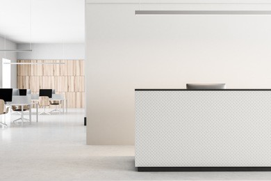 white reception desk standing on a concrete floor of a modern office. an open space office area in the background. 3d rendering mock up