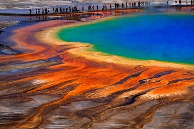 grand prismatice spring in yellowstone national park with tourists viewing the spectacular natural scene