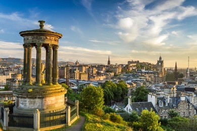 view of the castle from calton hill at sunset