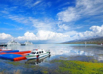 beautiful scenery of qinghai lake at harbour with many travelling ship and blue clear sky, the largest inland and salt water lake in china.