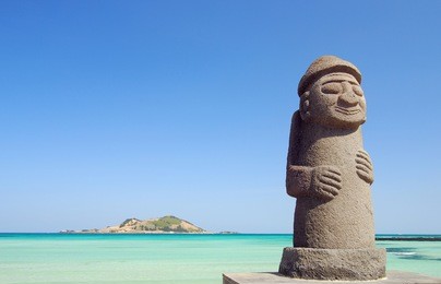 stone grandfather and beautiful sea scenery - jeju island, korea