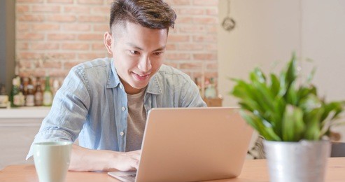 man sit and use notebook work in the morning