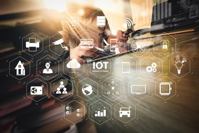 internet of things (iot) technology with ar (augmented reality) on vr dashboard. designer hand working with digital tablet and laptop computer and book stack on wooden desk as concept