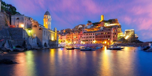 panorama of night fishing village vernazza with santa margherita di antiochia church and lookout tower of doria castle, five lands, cinque terre national park, liguria, italy.