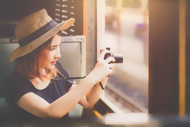 traveler on the train, beautiful woman traveler tourist taking photo window train city street travel ,travel and lifestyle concept.