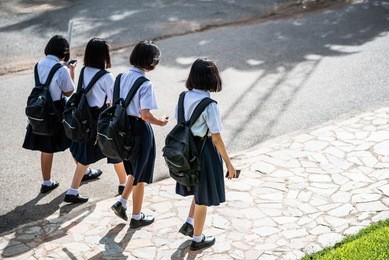 female high school students are going back home after school in thailand, southeast asia.