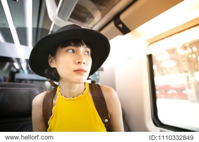 young woman sitting on the train. travelling to her destination alone.