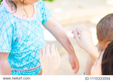 mother applying sunscreen lotion on her daughter.sunscreen protection uv sun light on the beach.