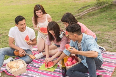 asian people take a picnic with watermelon