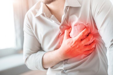 man having severe chest pain, suffering from heart attack.