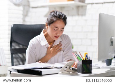 business woman heart disease she is working in an office.