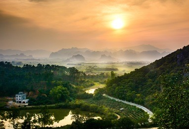 idyllic sunset over chinese rice fields and nature on guangxi province
