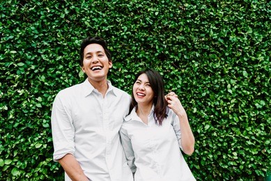 happy asian couple in love smiling and having fun while hugging outdoor