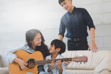 happy asian family at living room,happiness time of family playing at home,dad mom and baby are happiness coexistence,happy family concept and creating activities to strengthen skills for children.