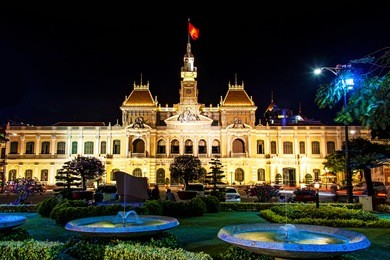 ho chi minh city hall in ho chi minh city, vietnam at night. it is known as ho chi minh city people's committee head office and was built in 1902-1908.