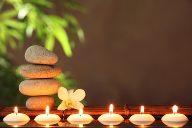 stack of zen stones and aromatic candles on table,zen concept.