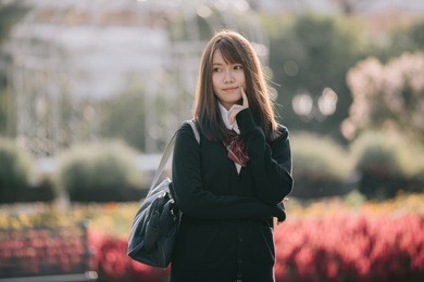 portrait of asian japanese school girl costume looking at park outdoor film vintage style