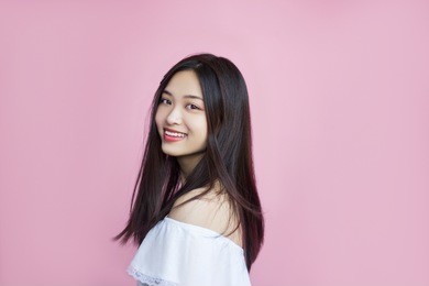 lovely woman, youth, happiness, positive, smiling face, happy eyes, cute smile, black hair, asia, chinese appearance, white casual blouse, pink background, activity, on the move