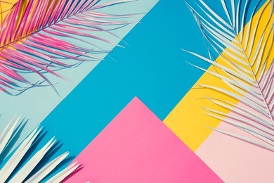 tropical bright colorful background with exotic painted tropical palm leaves. minimal fashion summer concept. flat lay.