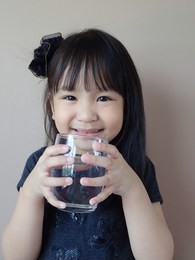 little asian girl drink water 