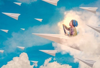 asian boy enjoys driving a paper plane on the blue sky heading to the horizon. the concept of business leadership, leading the organization to goals, learning and imagination.