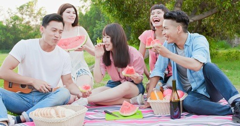 friends eat watermelon happily and enjoy go on a picnic