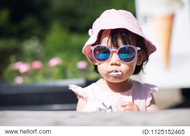 baby girl with sunglass eating icecream