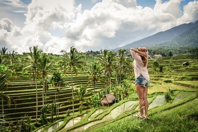 beautiful  woman looking at beautiful tegallalang rice terrace in bali, indonesia