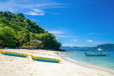 banana beach on coral (ko he) island on a sunny day, phuket, thailand 