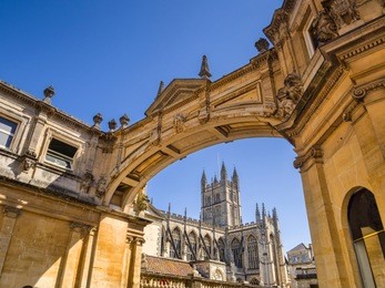 bath, somerset, england, uk - bath abbey seen through the york street arch.