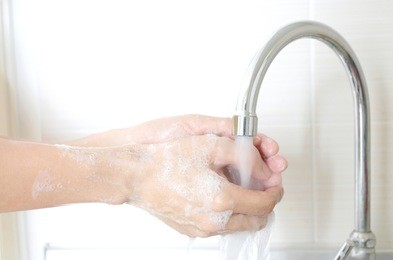 hand of beauty woman  wash your hands at the wash basin with foam, cleanse the skin and have water flowing through the hands. health and beauty concepts