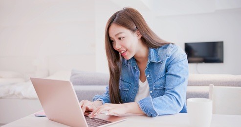 woman use phone and computer work at home