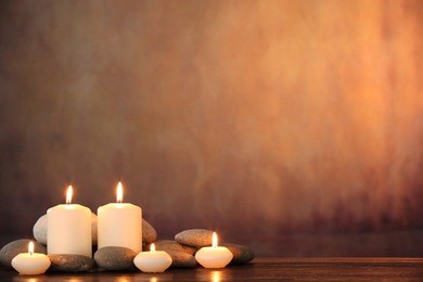 zen stones and aromatic candles on table,zen concept.