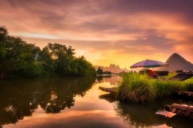 a raft parked on the banks of yangshuo river in yangshuo county, guilin, china