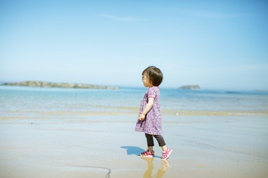 baby girl playing at summer beach