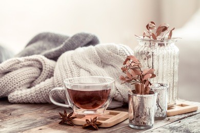 a cup of tea on a wooden table, the concept of autumn and home comfort